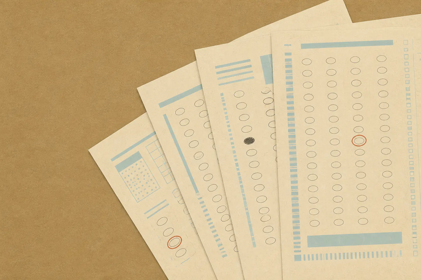 Blank optical answer sheets fanned across a kraft desk